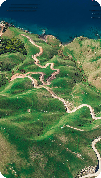 Panoramic aerial view of winding roads through lush hills